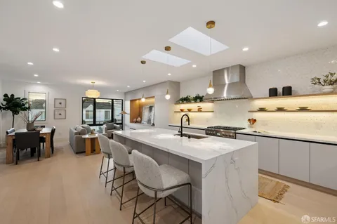 a kitchen with a stove a refrigerator and a dining table
