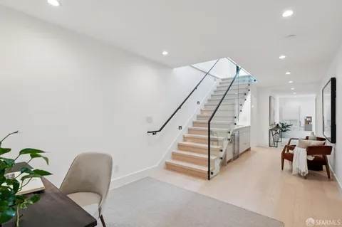 a living room with furniture and stairs
