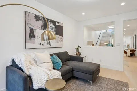 a living room with furniture and painting on the wall