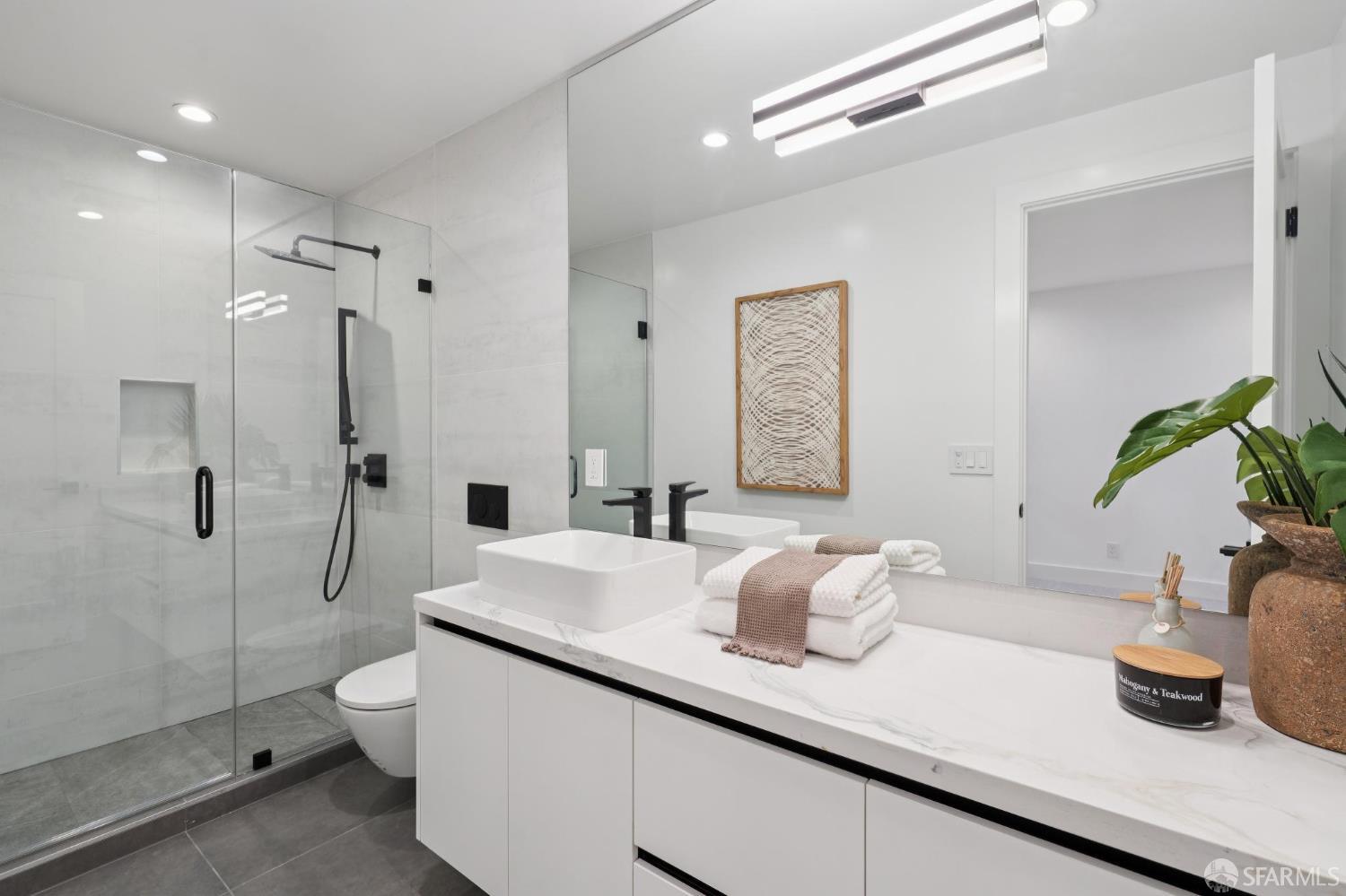1726 30th Avenue San Francisco, CA 94122 - Photo 27 of 34 a bathroom with a granite countertop sink a toilet and shower
