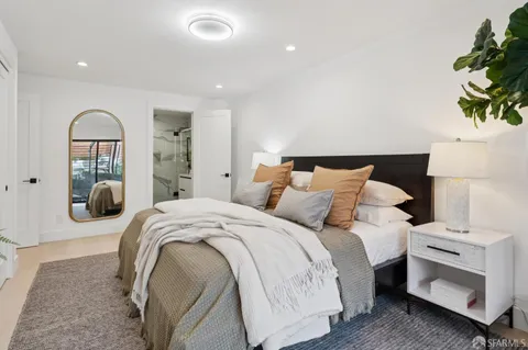 a bathroom with a sink a potted plant and a shower