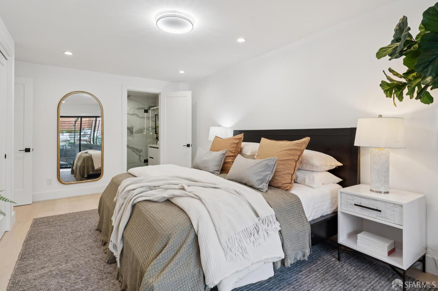 1726 30th Avenue San Francisco, CA 94122 - Photo 29 of 34 a spacious bedroom with a bed and a potted plant