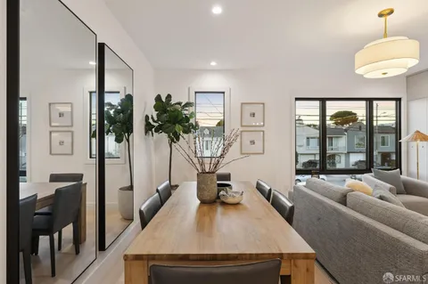 a living room with furniture a flat screen tv and a large window