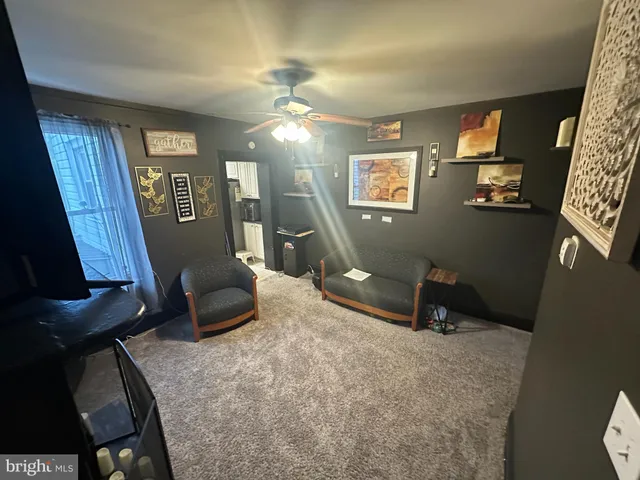 a view of a livingroom with furniture and a window