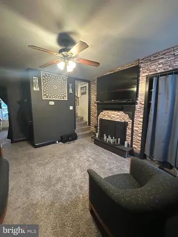 a living room with furniture and a fireplace
