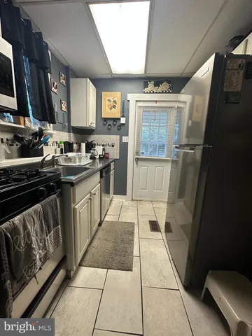 a kitchen with a sink stove and refrigerator