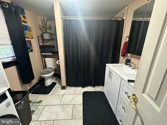 a bathroom with a bathtub a toilet and a shower