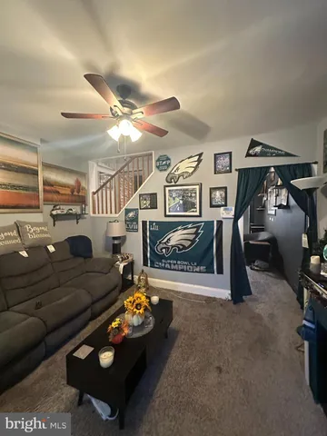 a living room with furniture and a gym machine