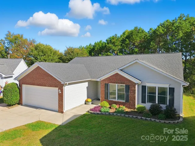 a aerial view of a house with a yard and potted plants