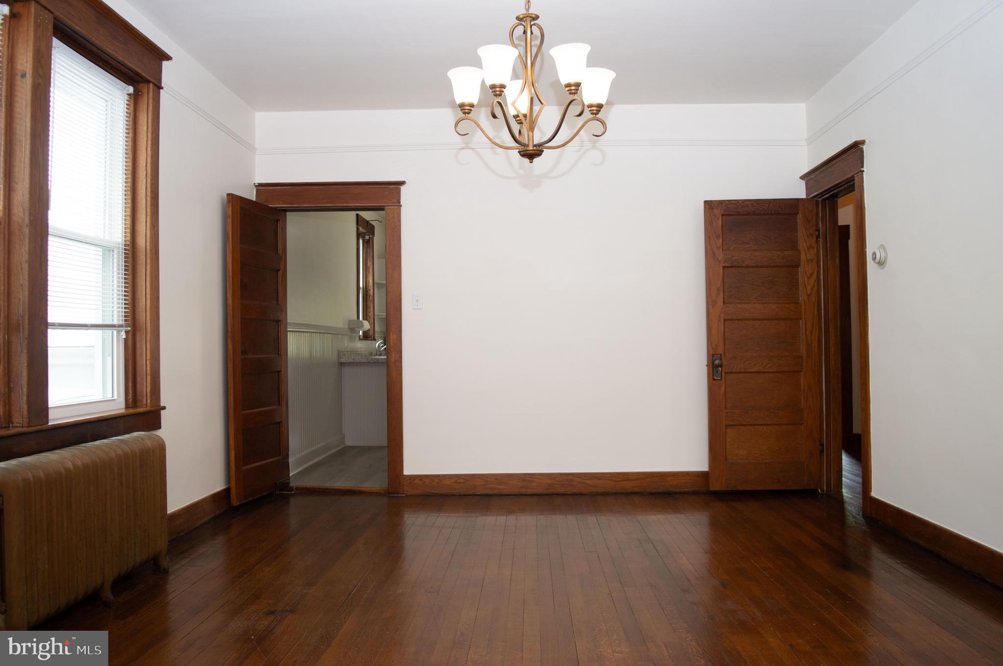 West Water Street Smithsburg, MD 21783 - Photo 11 of 23 wooden floor in an empty room with a window