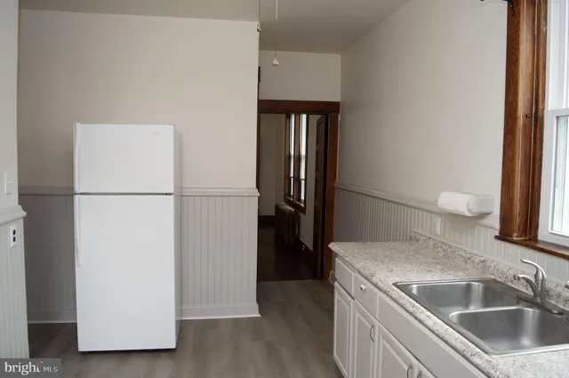 a kitchen with a refrigerator and a sink