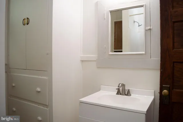 a bathroom with a sink and mirror