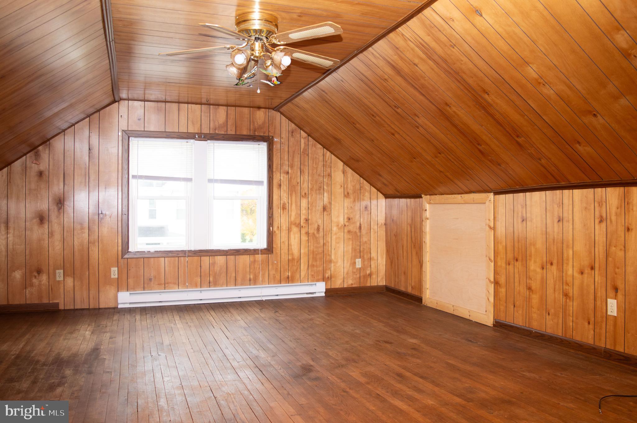 West Water Street Smithsburg, MD 21783 - Photo 21 of 23 a view of an empty room with wooden floor and a window