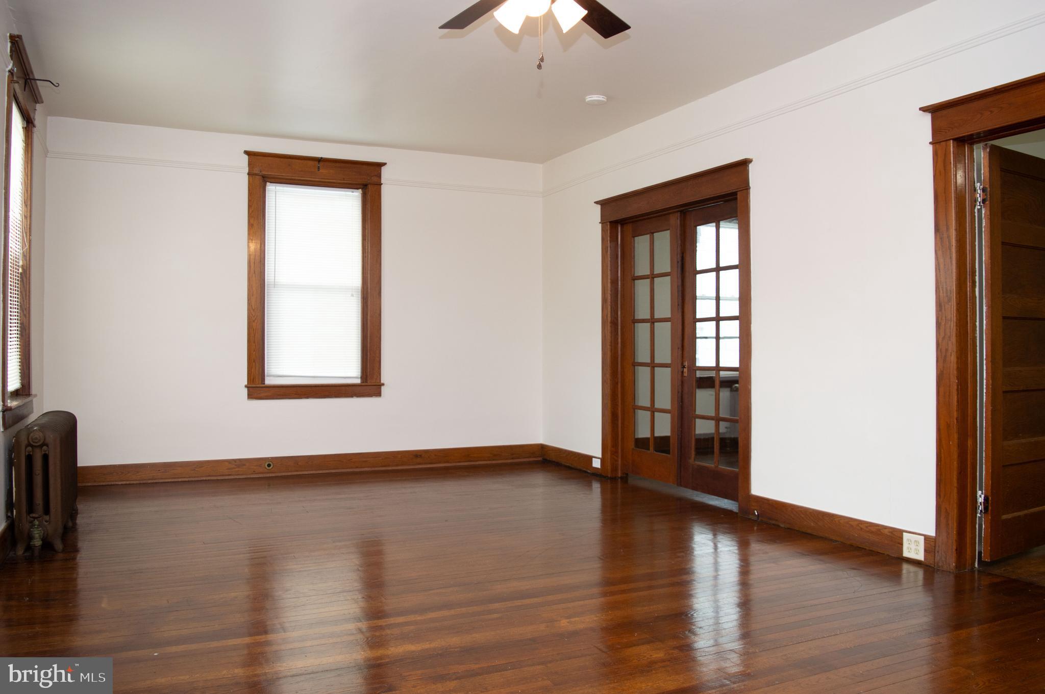 West Water Street Smithsburg, MD 21783 - Photo 6 of 23 a view of an empty room with window and wooden floor