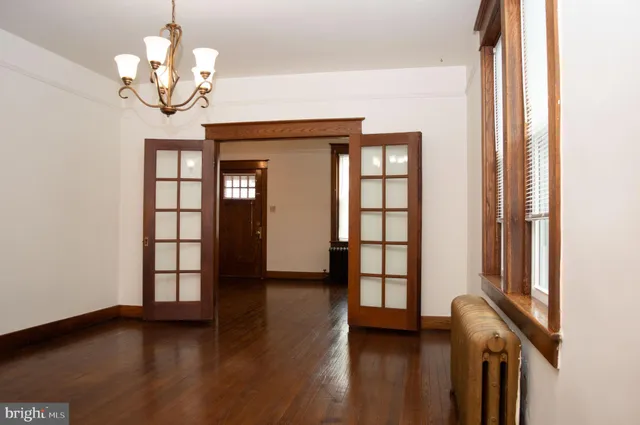 a view of a room with wooden floor and windows