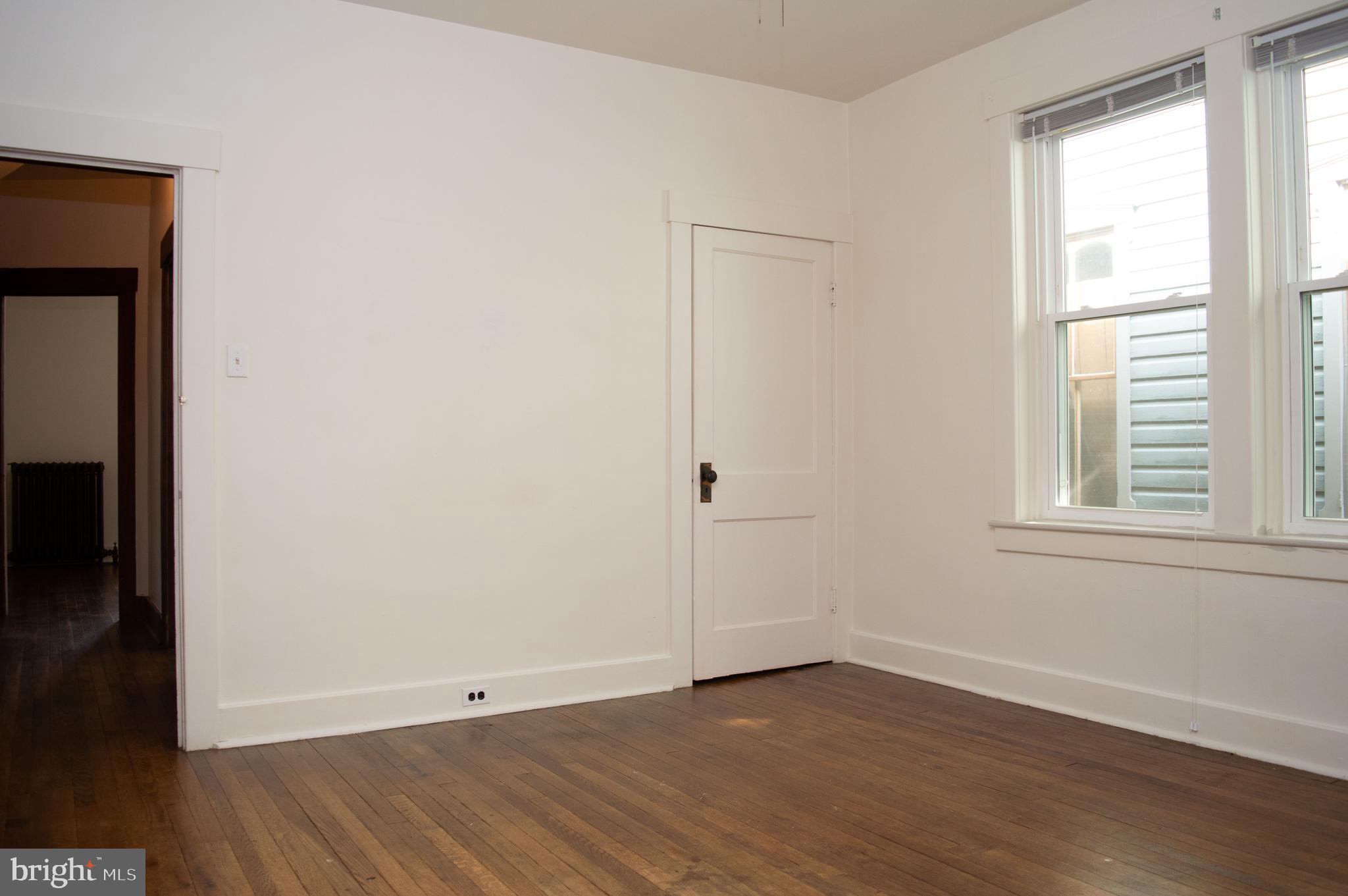West Water Street Smithsburg, MD 21783 - Photo 9 of 23 an empty room with wooden floor and windows