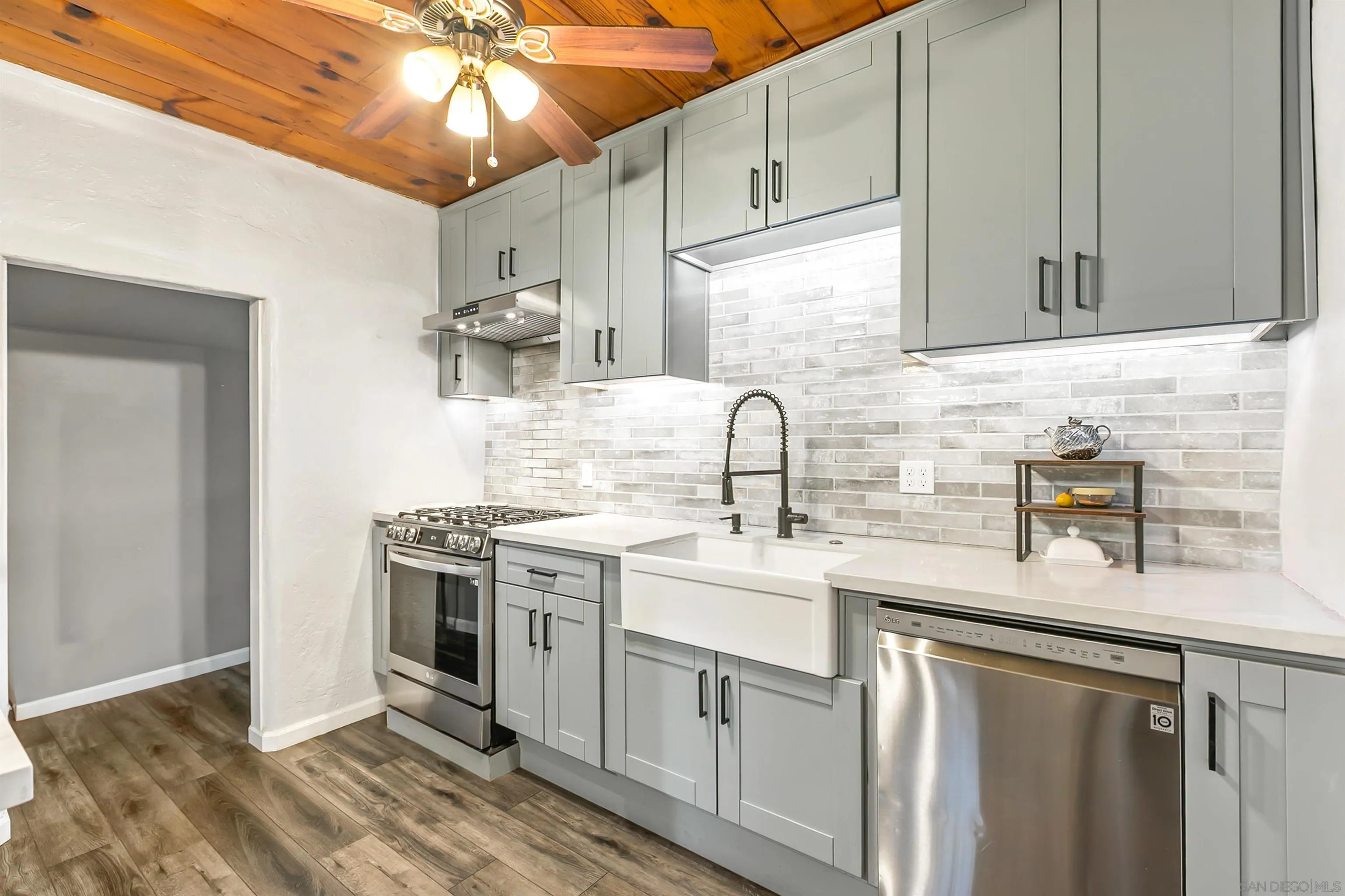 a kitchen with a sink cabinets and stainless steel appliances