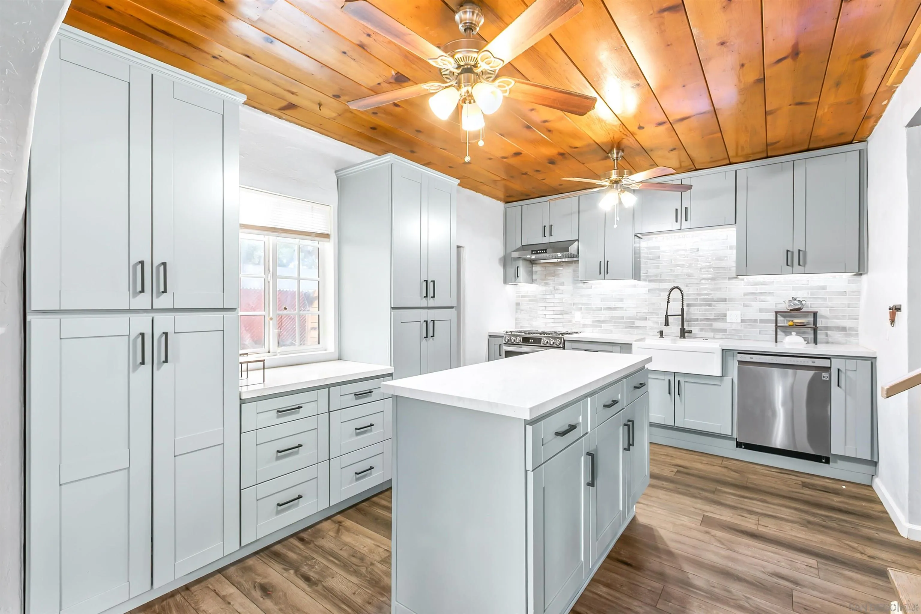 2414 Sage Drive Campo, CA 91906 - Photo 25 of 33 a kitchen with white cabinets and white appliances