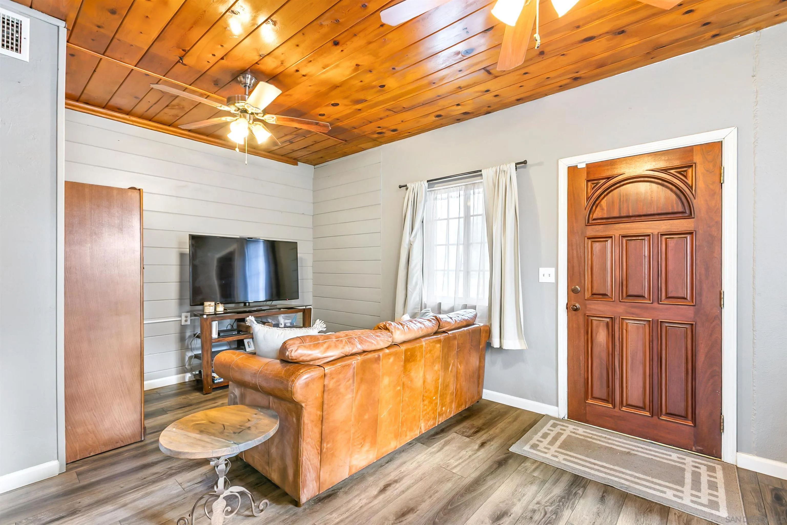 2414 Sage Drive Campo, CA 91906 - Photo 29 of 33 a living room with furniture a flat screen tv and a table