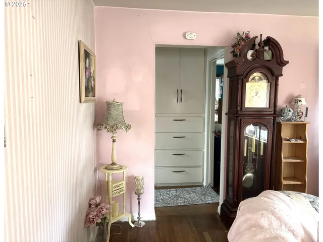 a living room with furniture a flat screen tv and a window