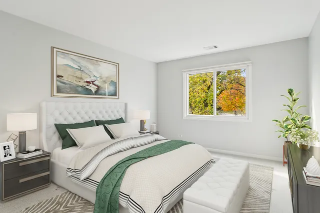 a bedroom with a bed and a painting on the wall