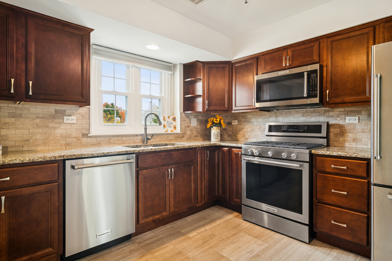 534 Park View Terrace, Unit 534 Buffalo Grove, IL 60089 - Photo 6 of 17 a kitchen with stainless steel appliances granite countertop a stove microwave and sink