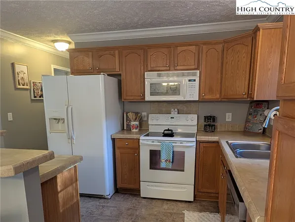 a kitchen with a stove top oven and refrigerator