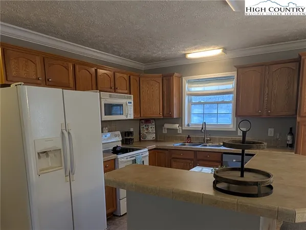 a kitchen with a refrigerator a sink and cabinets