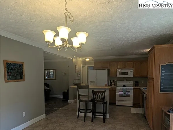 a view of a dining room with furniture and a chandelier