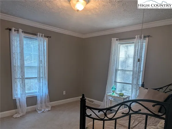 a view of a room that has a window and wooden floor