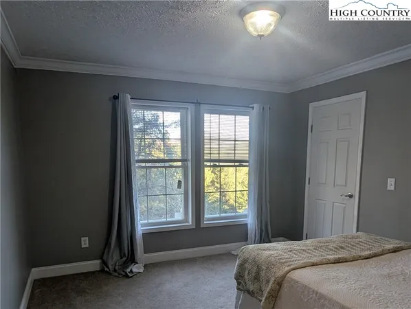 a spacious bedroom with a bed and a window