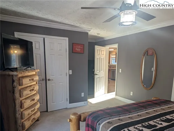 a bedroom with a bed and a flat tv screen