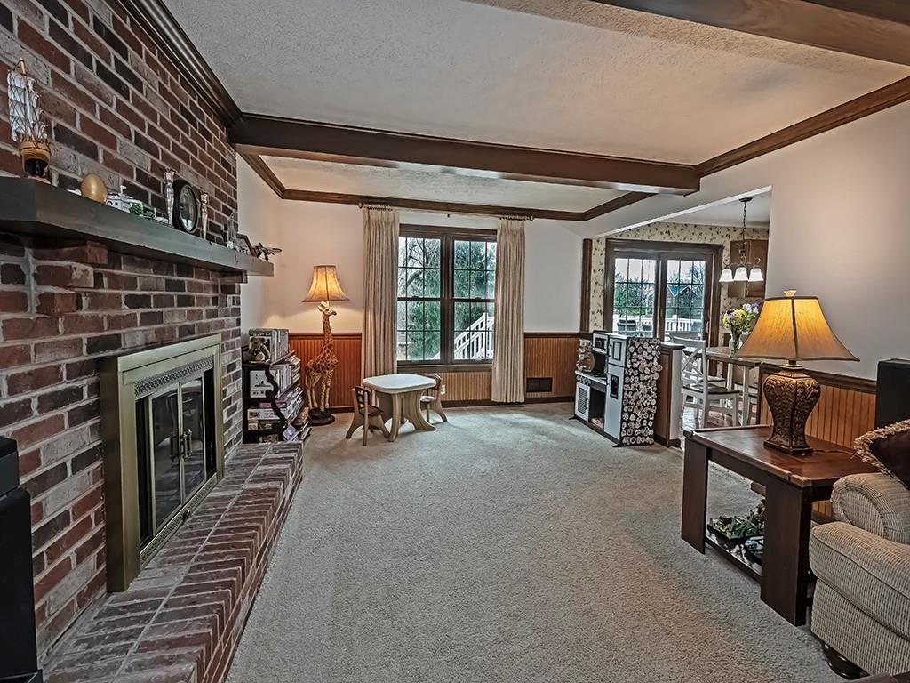 402 Dorseyville Road Pittsburgh, PA 15215 - Photo 12 of 33 a living room with furniture and a fireplace