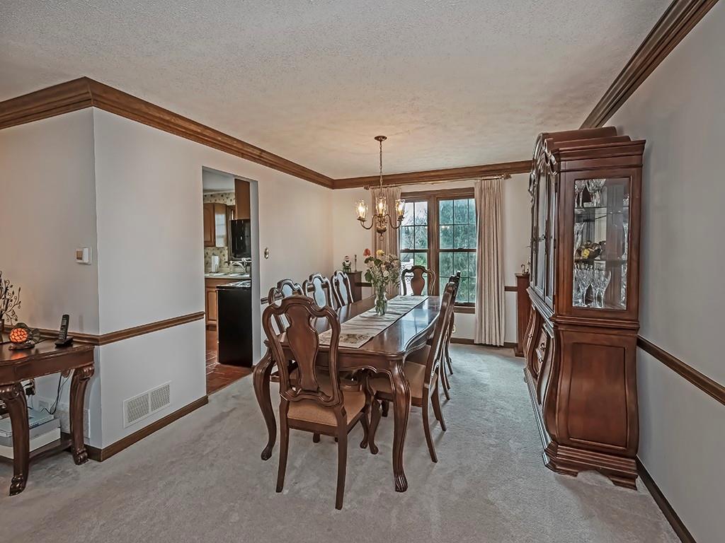 402 Dorseyville Road Pittsburgh, PA 15215 - Photo 7 of 33 a view of a dining room with furniture and a chandelier