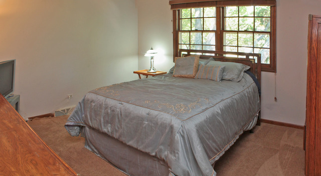 1636 Fender Road Naperville, IL 60565 - Photo 12 of 20 a bedroom with a bed and a window