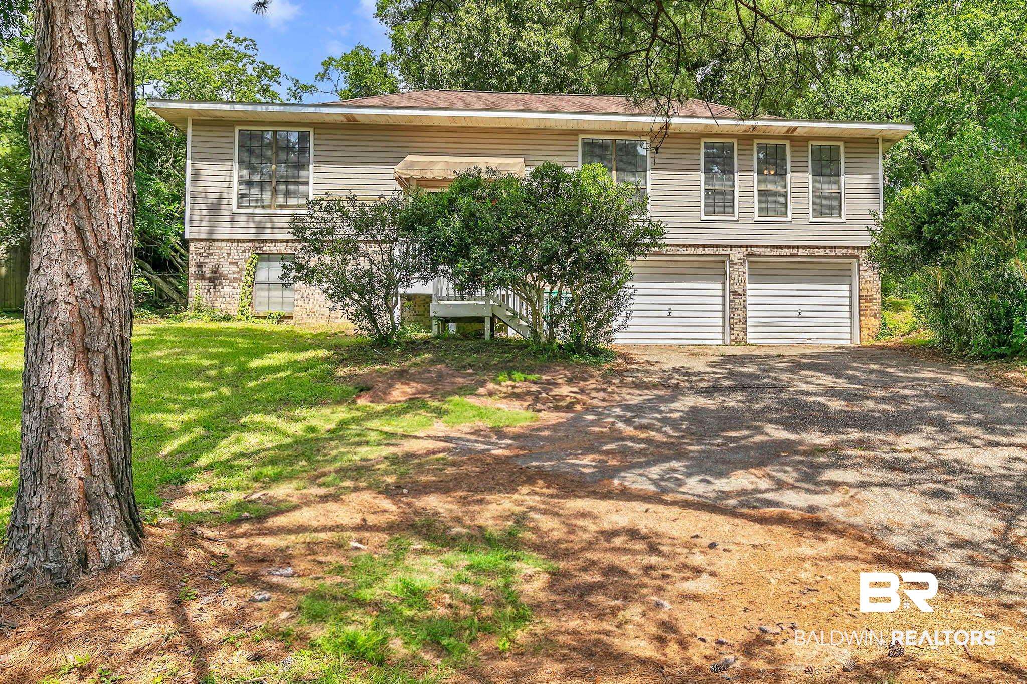 45 Caisson Trace Spanish Fort, AL 36527 - Photo 2 of 46 Split foyer home with driveway, brick siding, an attached garage, and a front lawn
