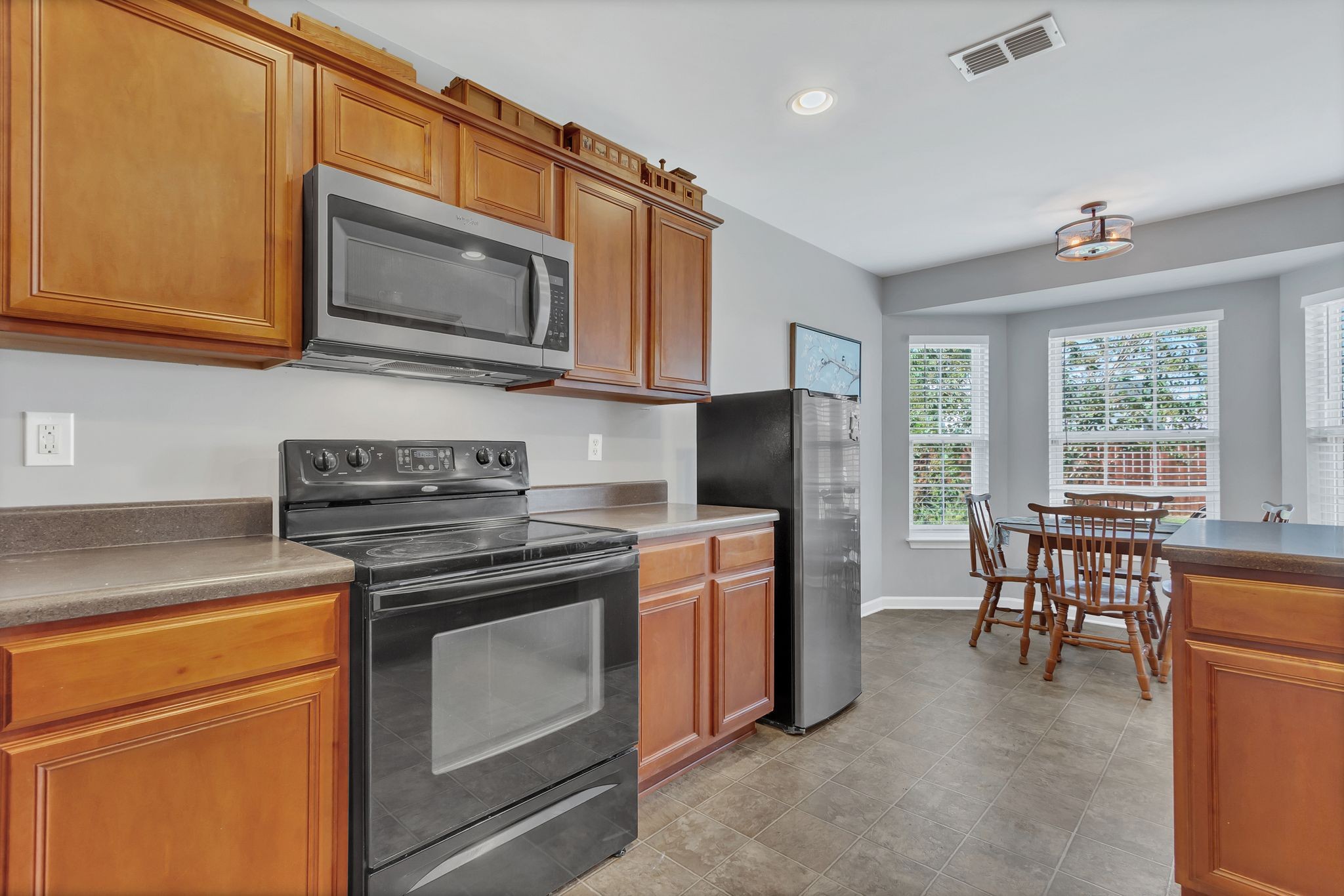 2032 Red Jacket Trace Spring Hill, TN 37174 - Photo 11 of 33 a kitchen with stainless steel appliances granite countertop a stove microwave refrigerator sink and cabinets