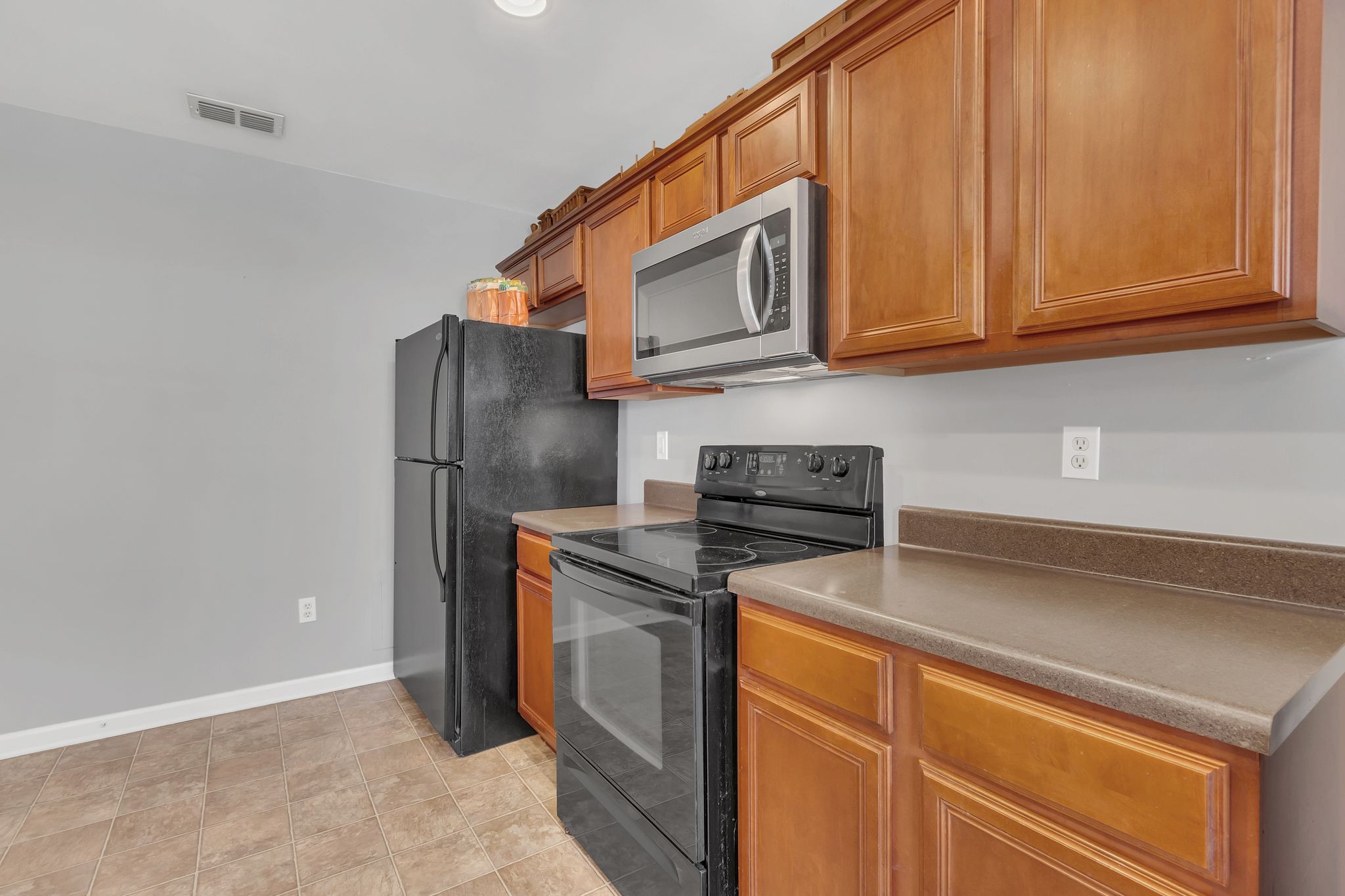 2032 Red Jacket Trace Spring Hill, TN 37174 - Photo 14 of 33 a kitchen with stainless steel appliances granite countertop a refrigerator and a stove top oven