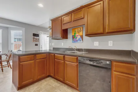 a kitchen with stainless steel appliances granite countertop a sink and cabinets