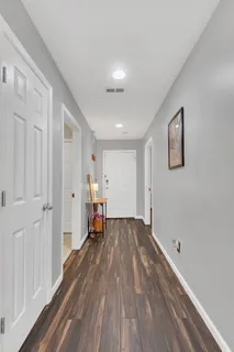 a view of empty room with wooden floor