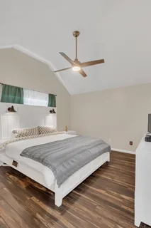 a bedroom with a bed and a ceiling fan