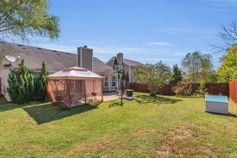 a view of a house with backyard porch and sitting area