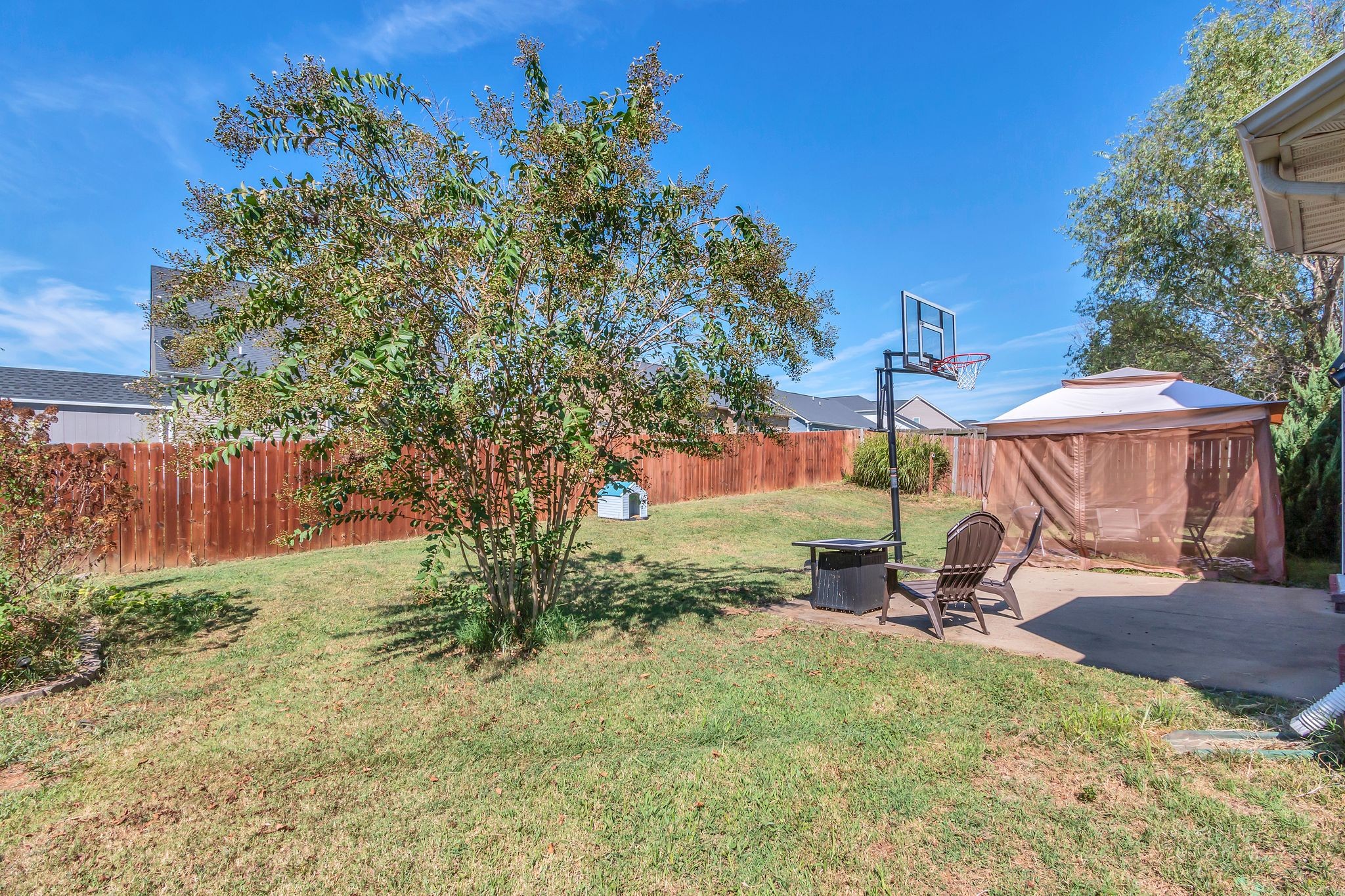 2032 Red Jacket Trace Spring Hill, TN 37174 - Photo 30 of 33 a view of a backyard with table and chairs under an umbrella