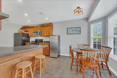 a kitchen with stainless steel appliances a refrigerator and microwave