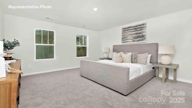 a bed room with a bed and three windows