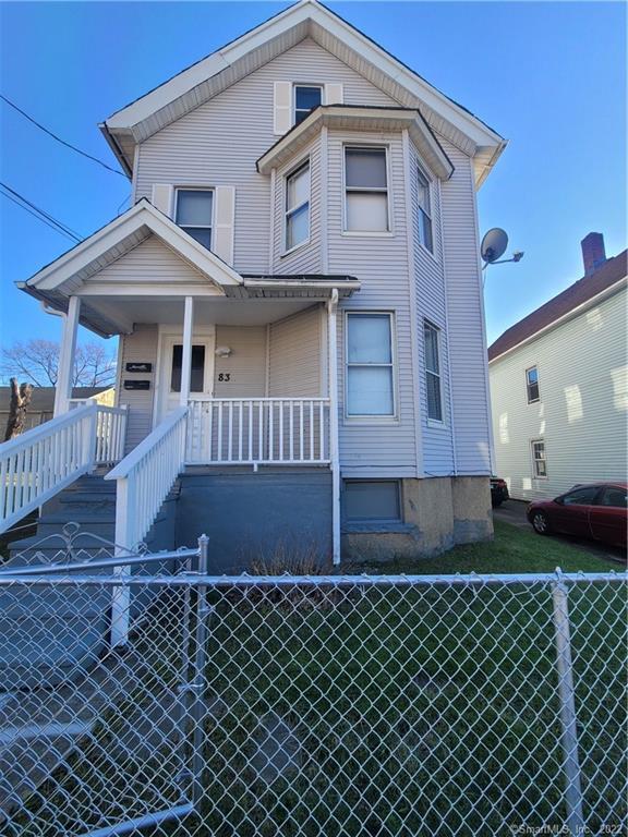 83 Johnson Street Bridgeport, CT 06604 - Photo 1 of 1 a front view of a house with a garden
