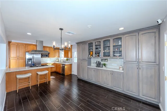 a view of kitchen with stainless steel appliances granite countertop a sink and cabinets