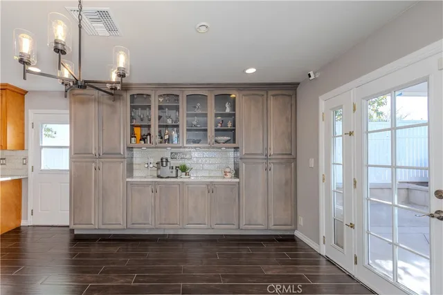 a bathroom with a toilet a sink a mirror a shower a vanity and window