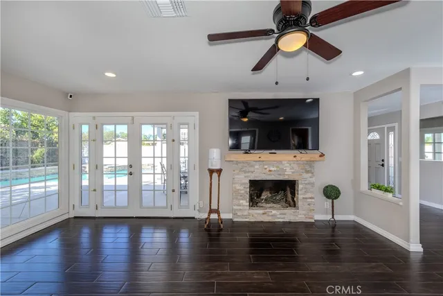 a view of a room with wooden floor table and chairs