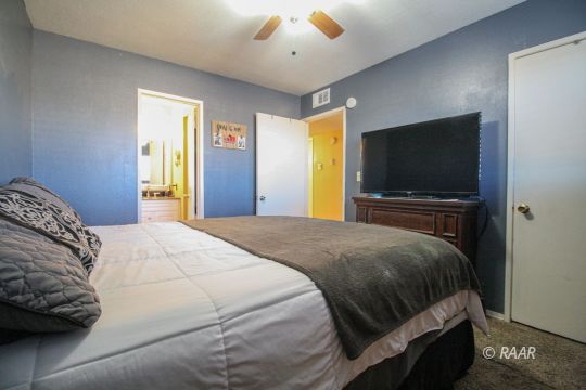 632 South Nevada Street Ridgecrest, CA 93555 - Photo 23 of 29 a bedroom with a bed and a flat screen tv